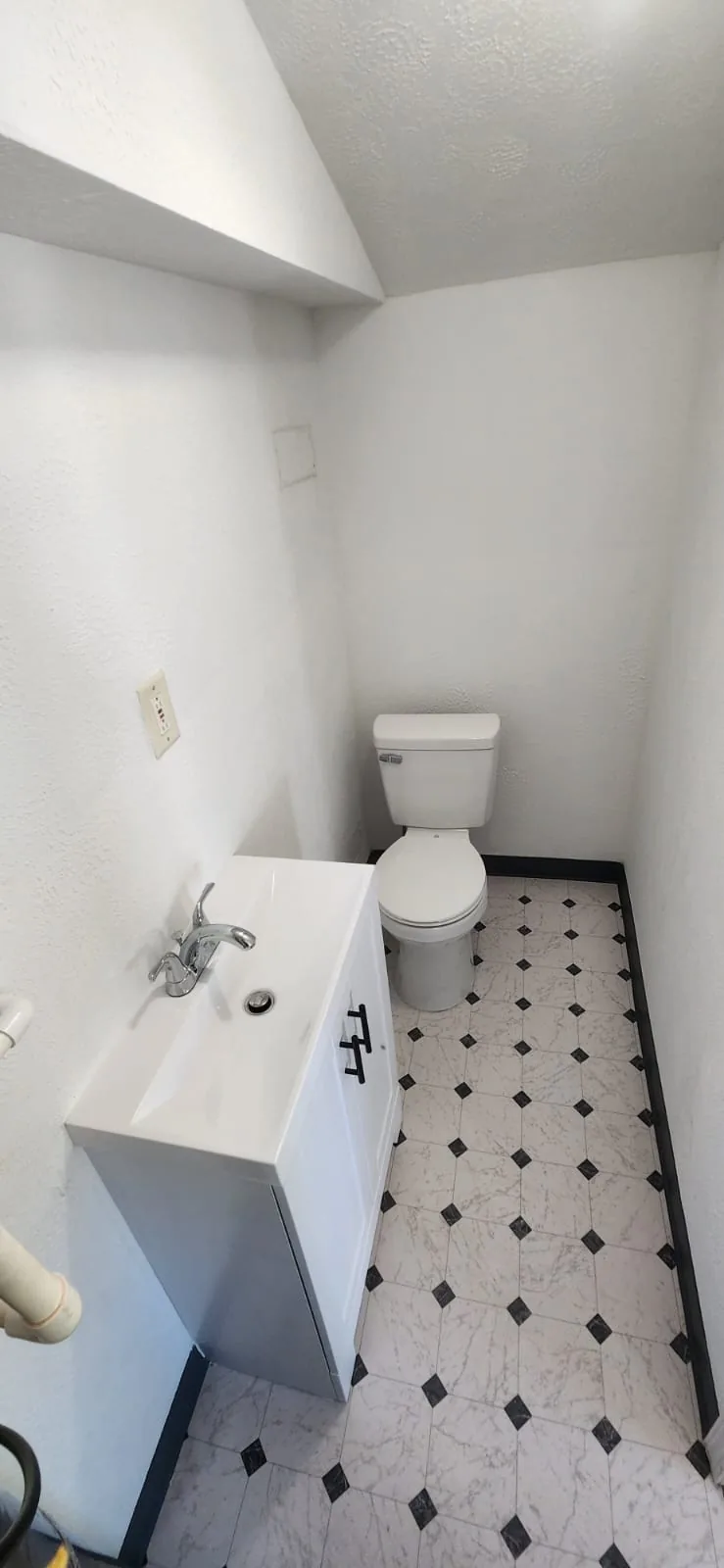 Modern shower installation — frameless glass enclosure, rain showerhead, bright clean tile, daylight bathroom