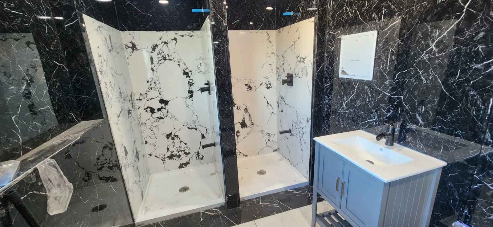 Completed bathroom sink installation — bright white modern bathroom with chrome fixtures, clean tile walls, well-lit professional finish